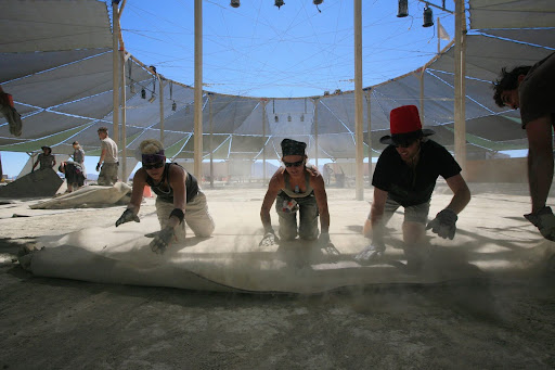 Volunteers putting down carpet in Center Camp