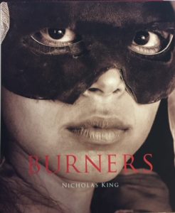 Person with black mask over their eyes. 