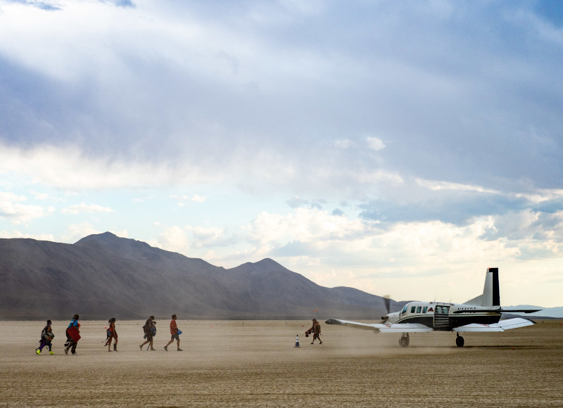 Boarding a small airplane at Burning Man's temporary airport in the Black Rock Desert of Nevada.