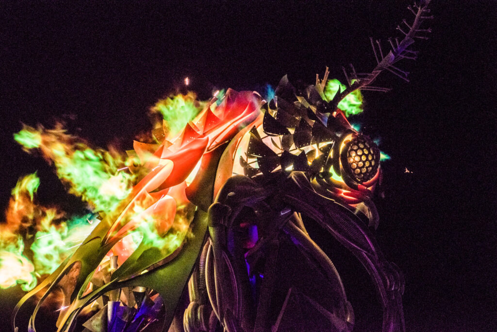 A moth sculpture with flaming winds and antennae 