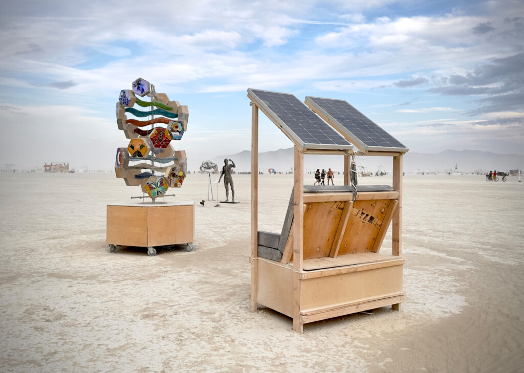 A image of a cleverly constructed bench seat for solar charging and battery storage, located in the 2023 Art Garden.