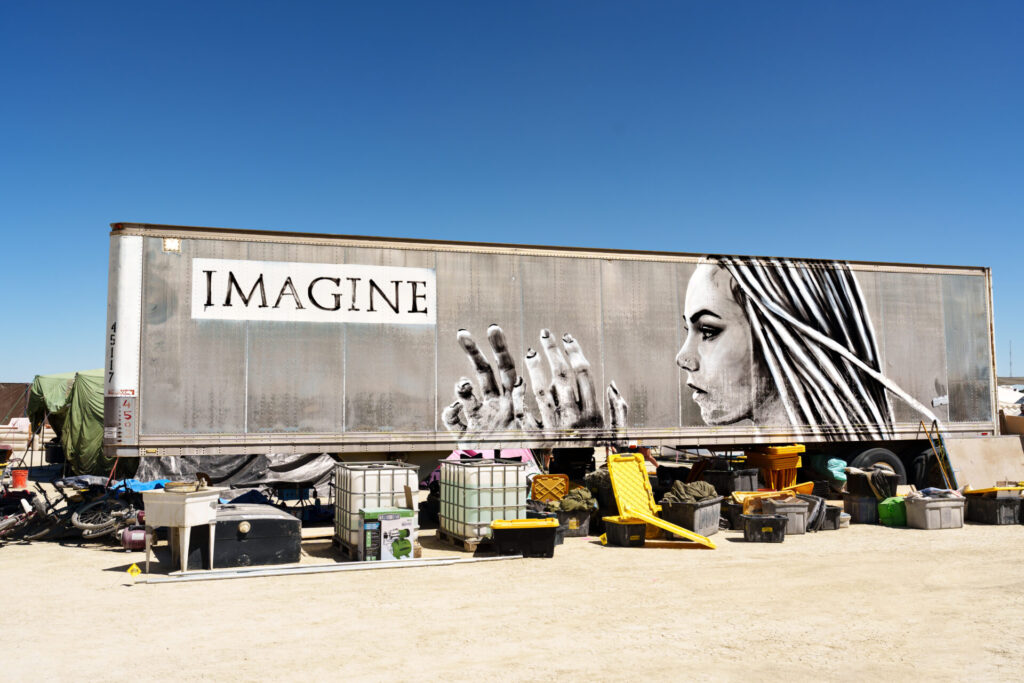A camp support trailer with image of a creative woman that says Imagine