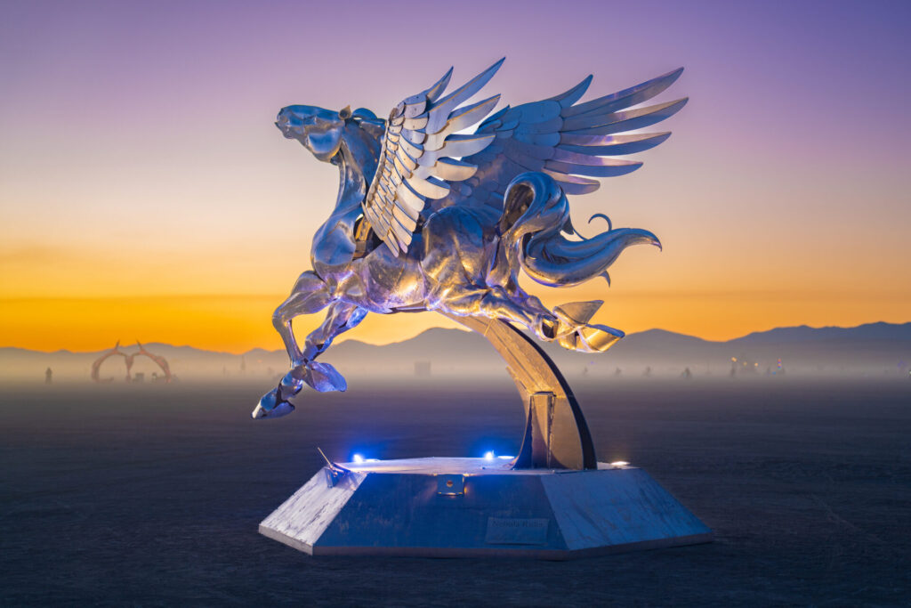 A pegasus sculpture gleams in the evening sun.