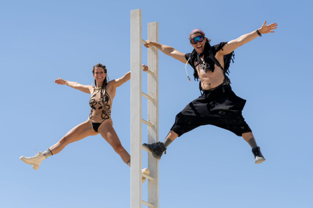 Two people at the top of a ladder