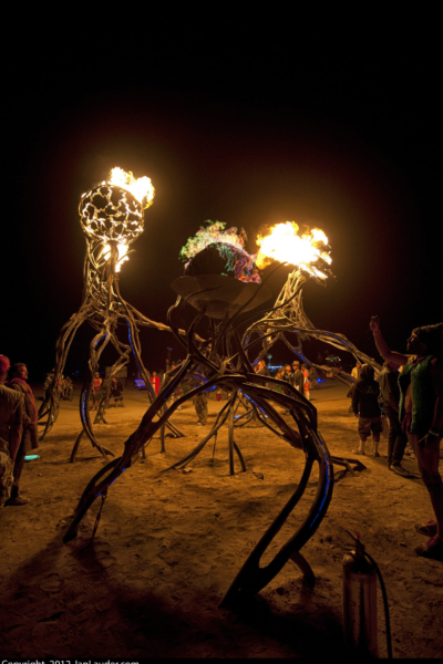 metal orbs filled with fire sit atop spindly twisting legs