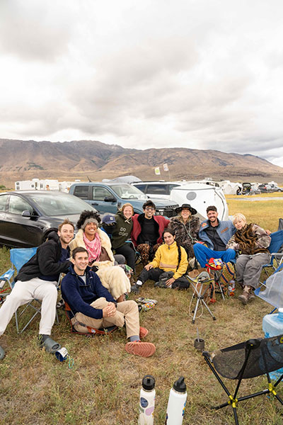 A group of young people sitting in camp chairs at Fly Ranch