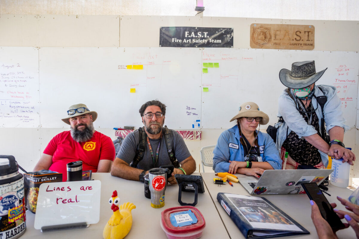 Volunteers sit at a table