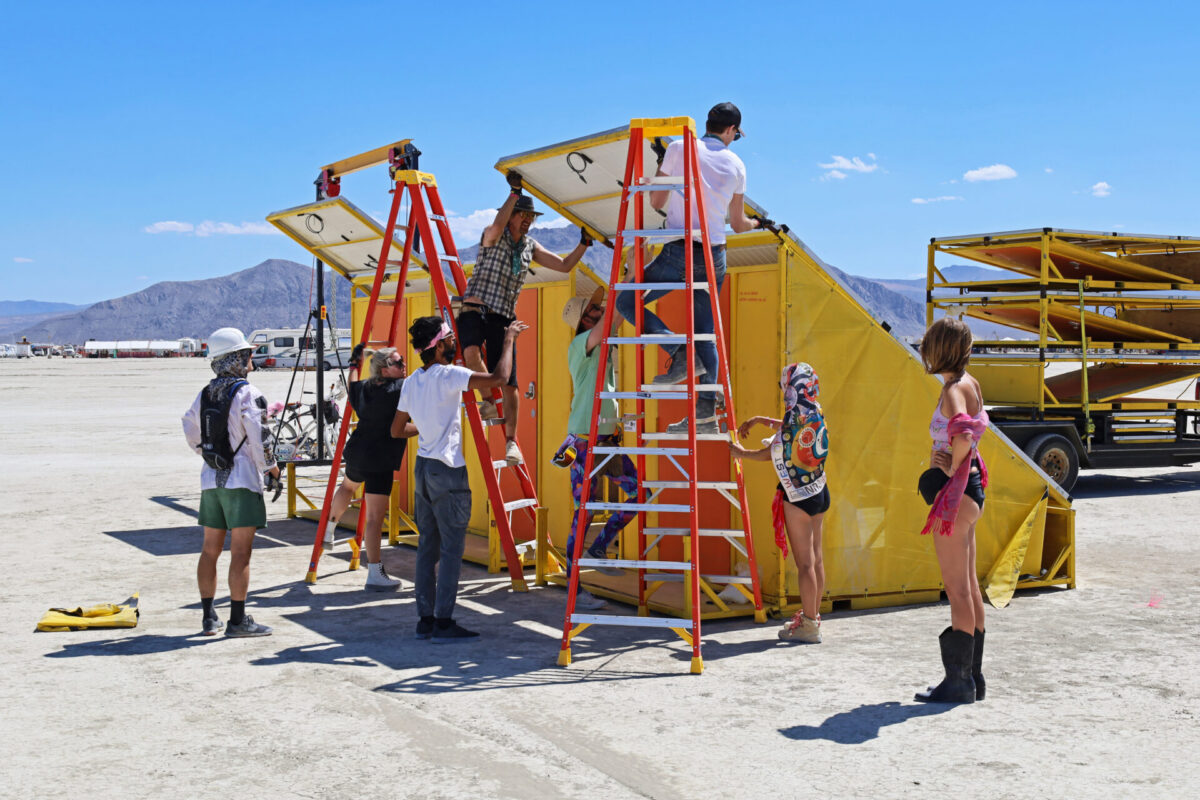 A group of people assembling solar panels on platforms